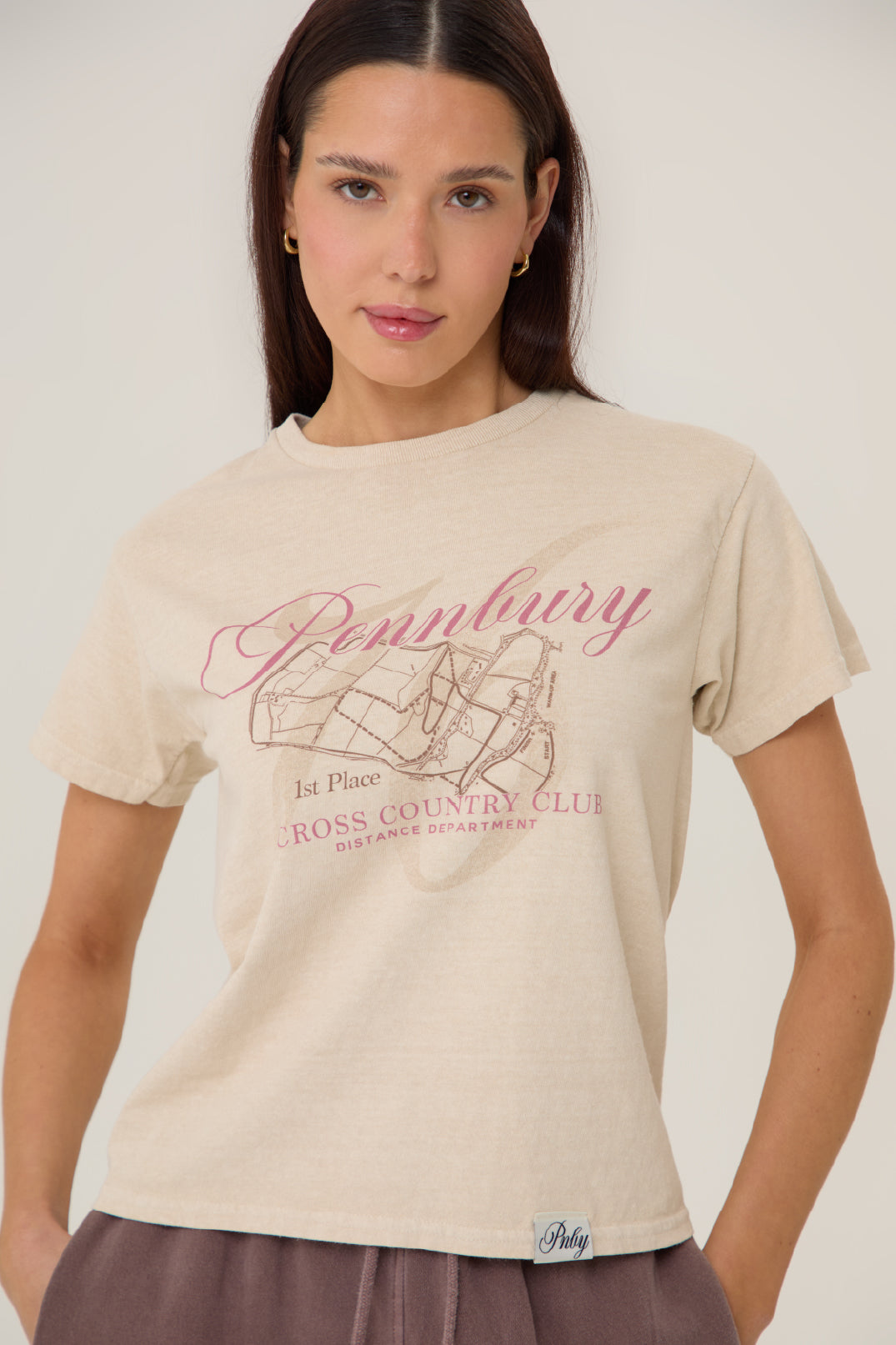Model wearing Pennbury Cross Country baby tee with joggers