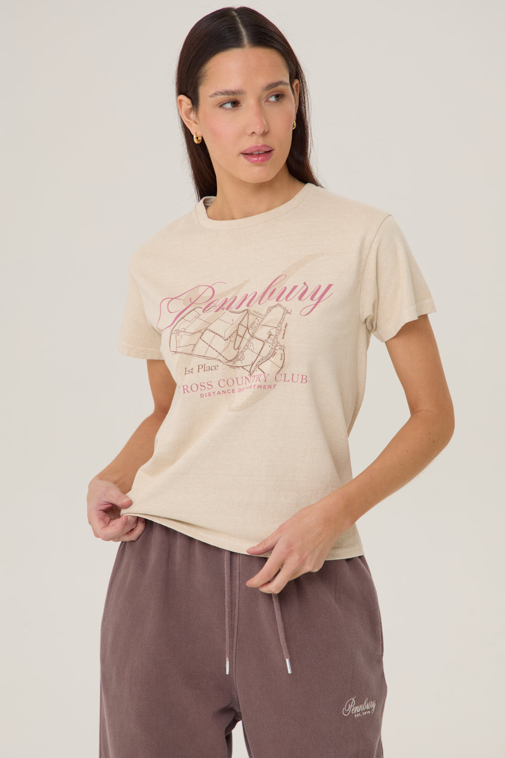 Model wearing Pennbury Cross Country baby tee with joggers