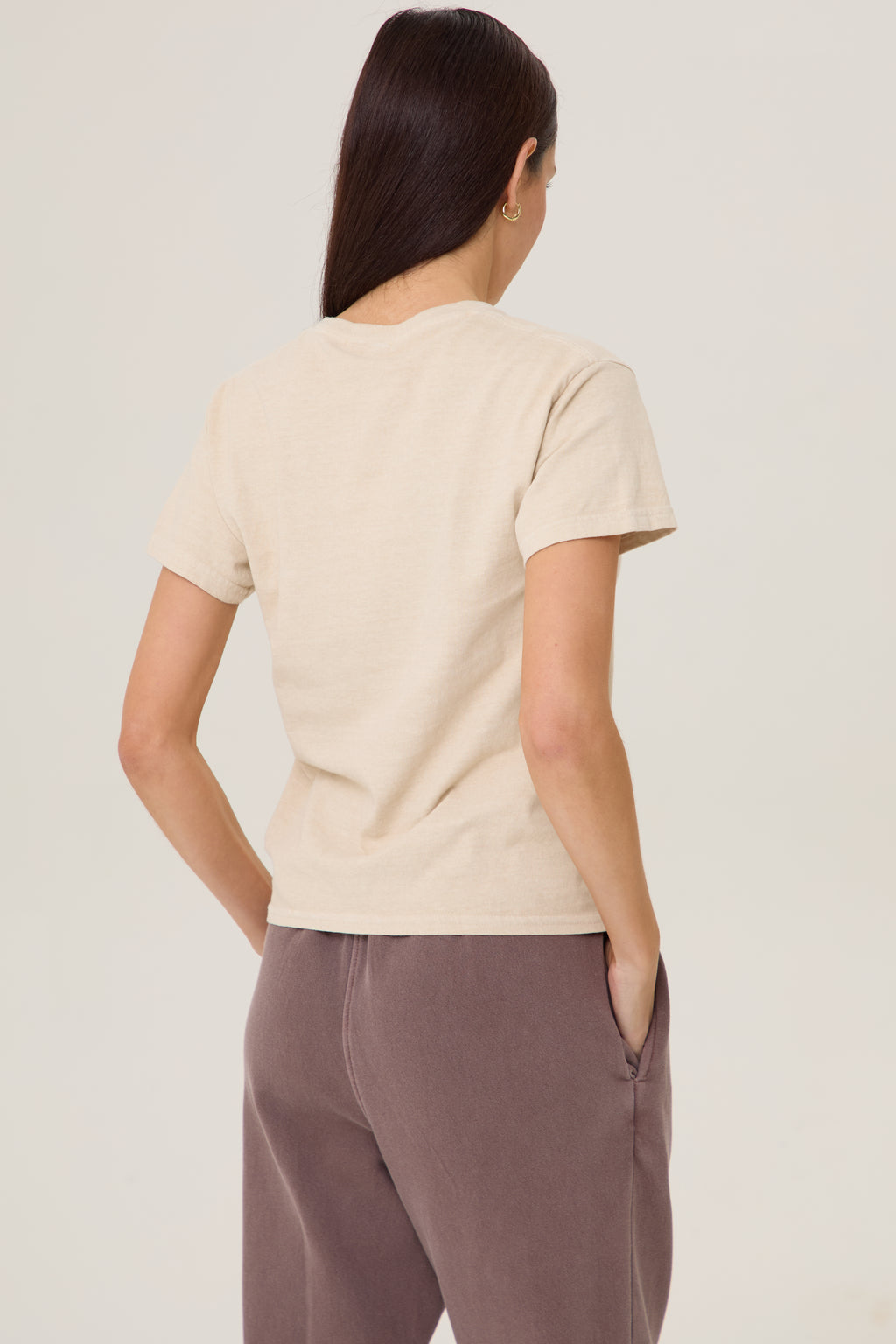 Model wearing Pennbury Cross Country baby tee with joggers