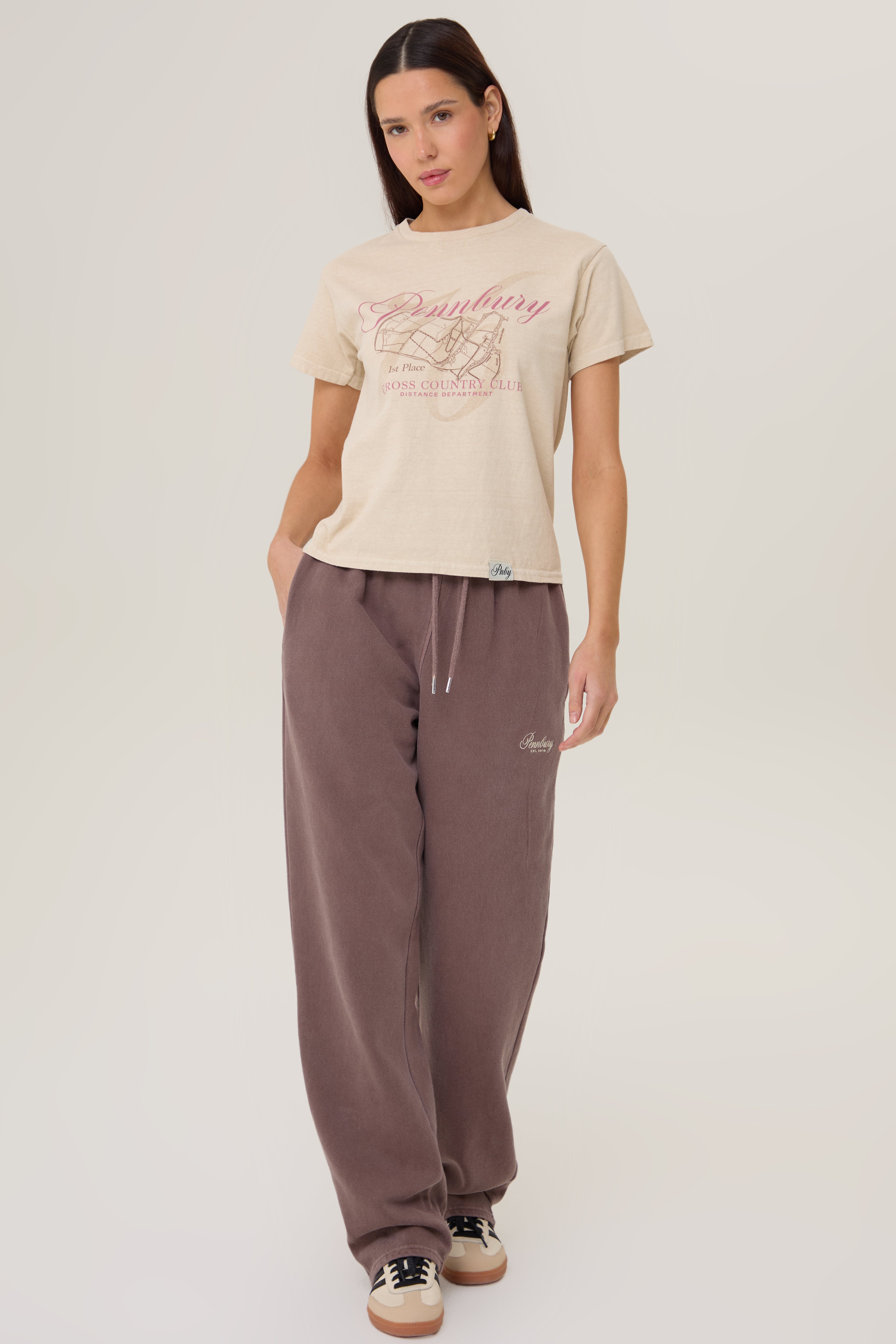 Model wearing Pennbury Cross Country baby tee with joggers