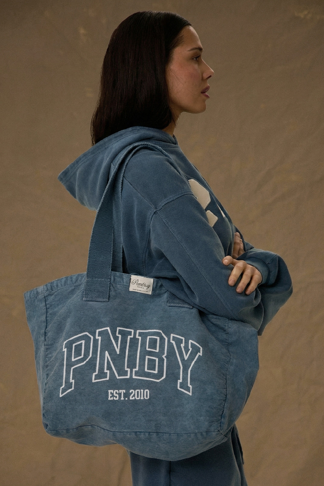 Model carrying Pennbury PNBY vintage navy canvas tote bag