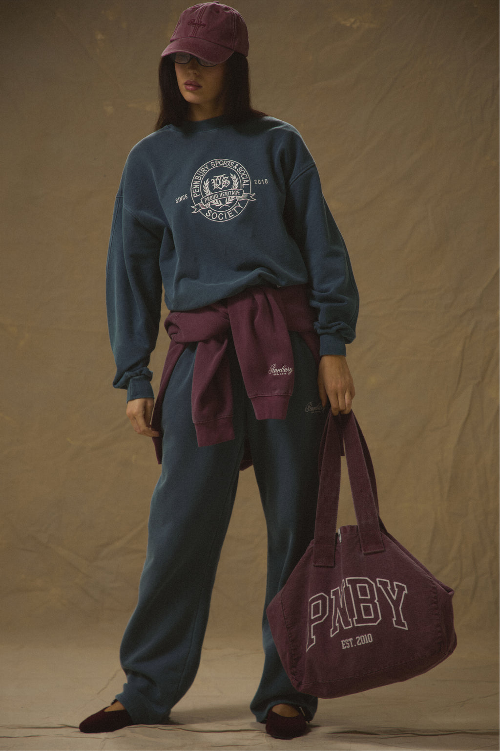 Model carrying Pennbury PNBY vintage wine canvas tote bag