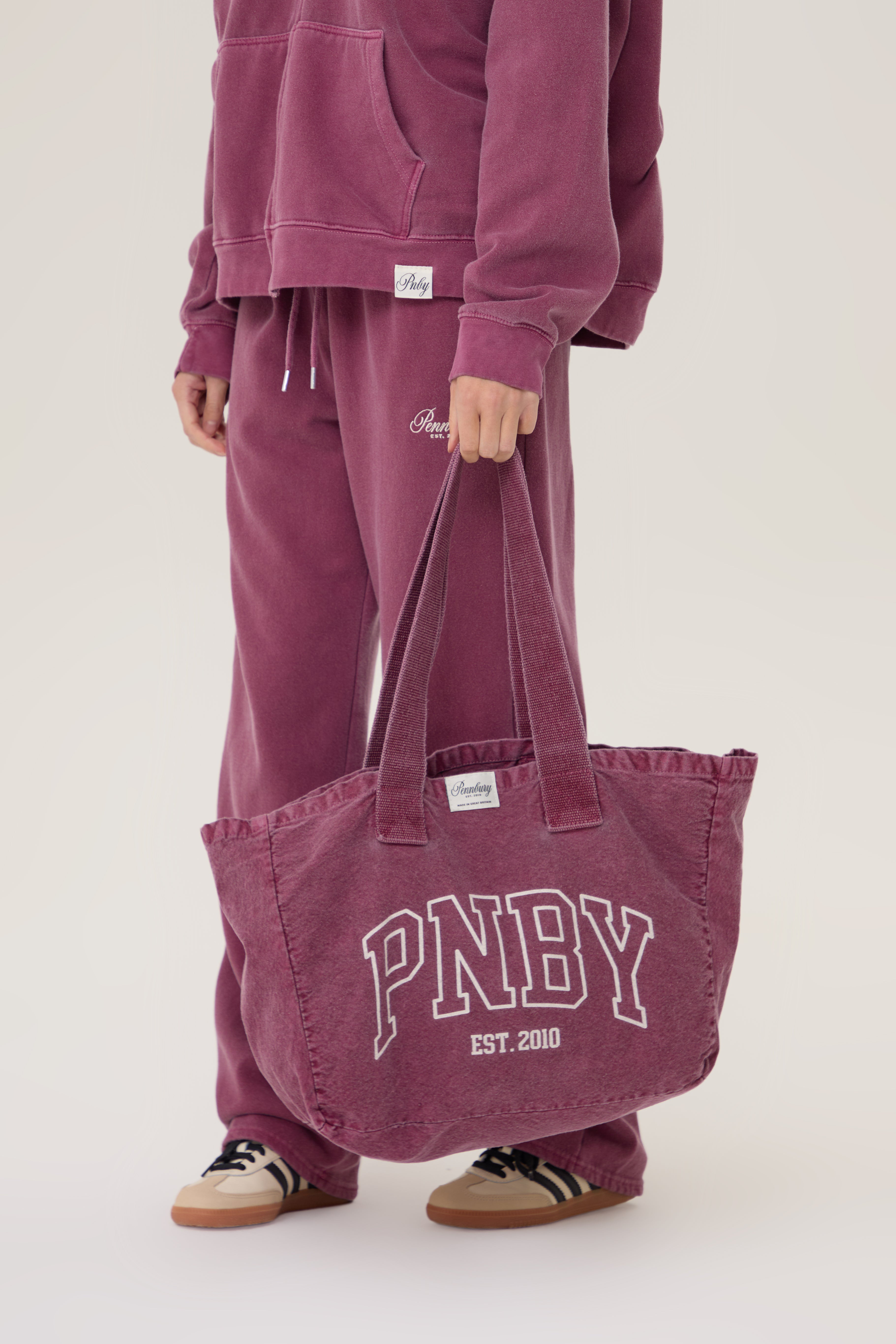 Model carrying Pennbury PNBY vintage wine canvas tote bag