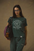 Model wearing Pennbury Pavilion baby tee in racing green with joggers