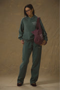 Model wearing Pennbury Racing Green straight leg joggers with hoodie