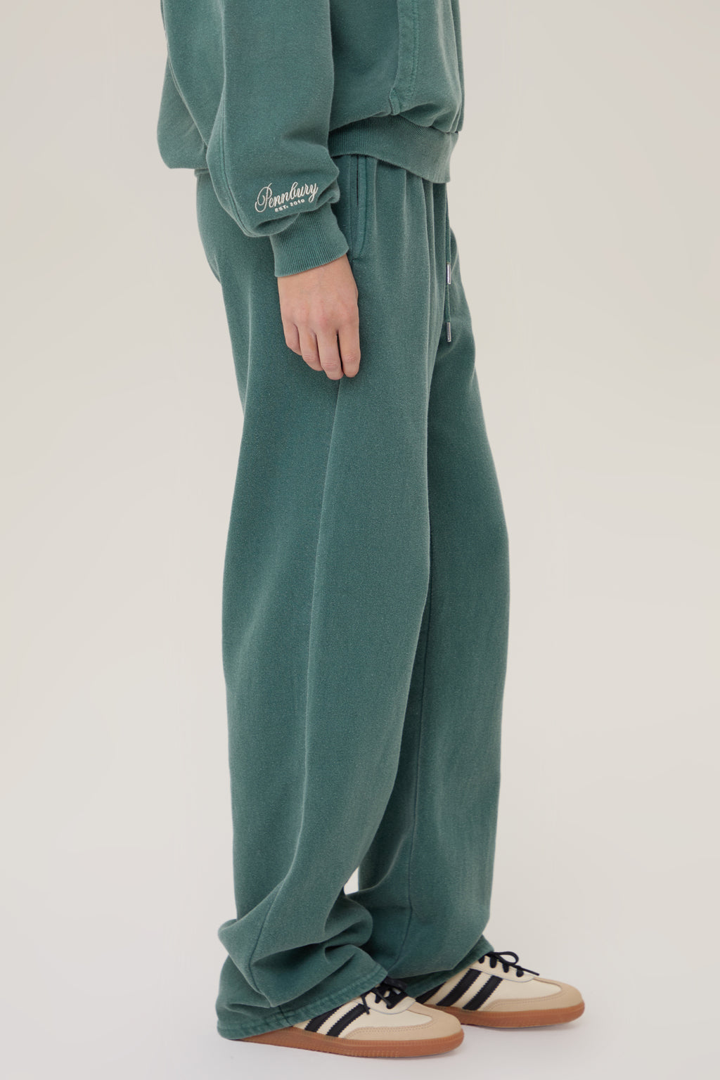 Model wearing Pennbury Racing Green straight leg joggers with sweatshirt