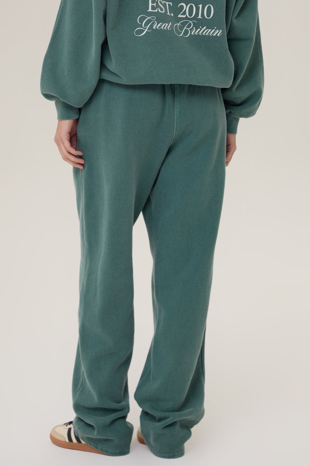 Model wearing Pennbury Racing Green straight leg joggers with hoodie