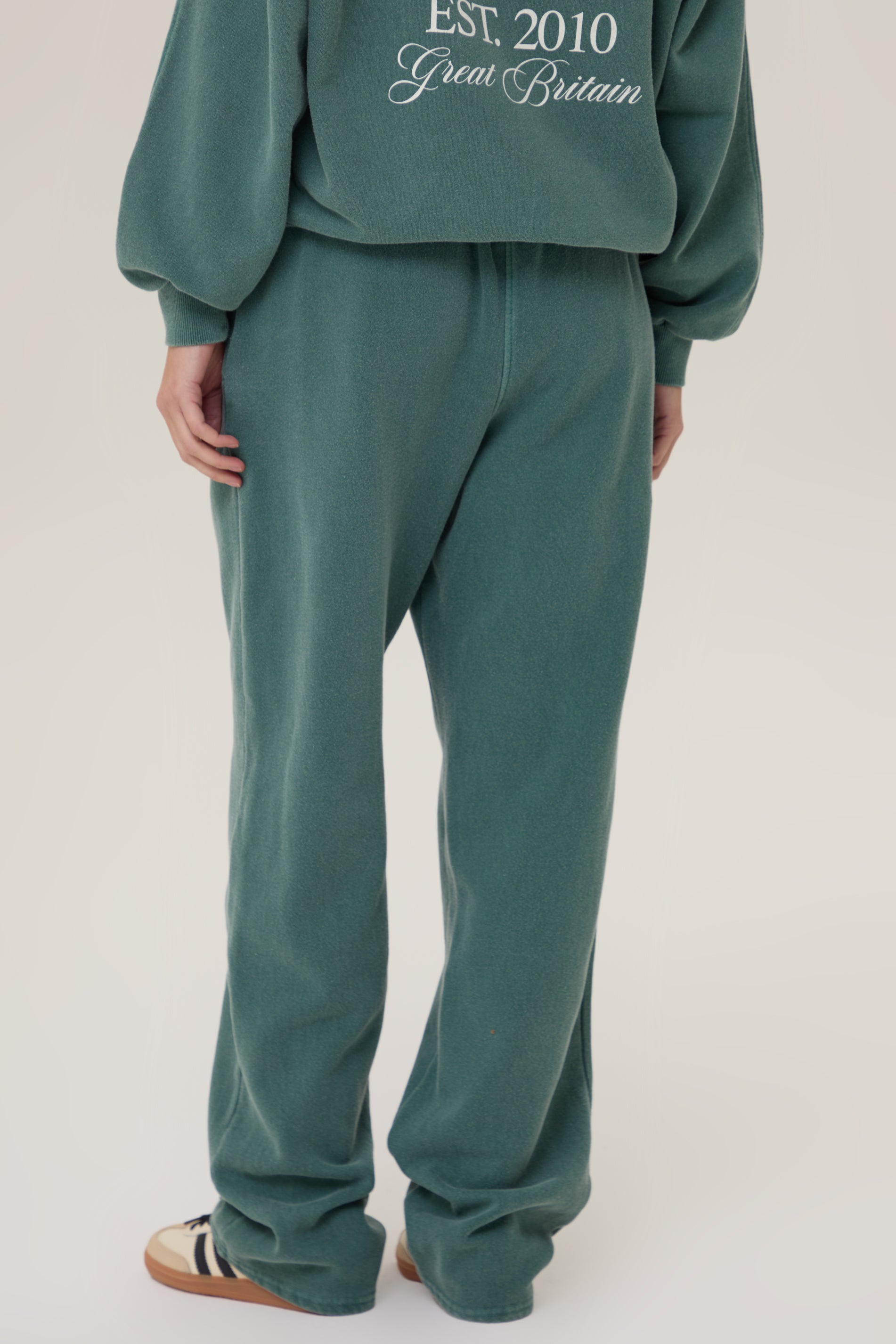 Model wearing Pennbury Racing Green straight leg joggers with hoodie