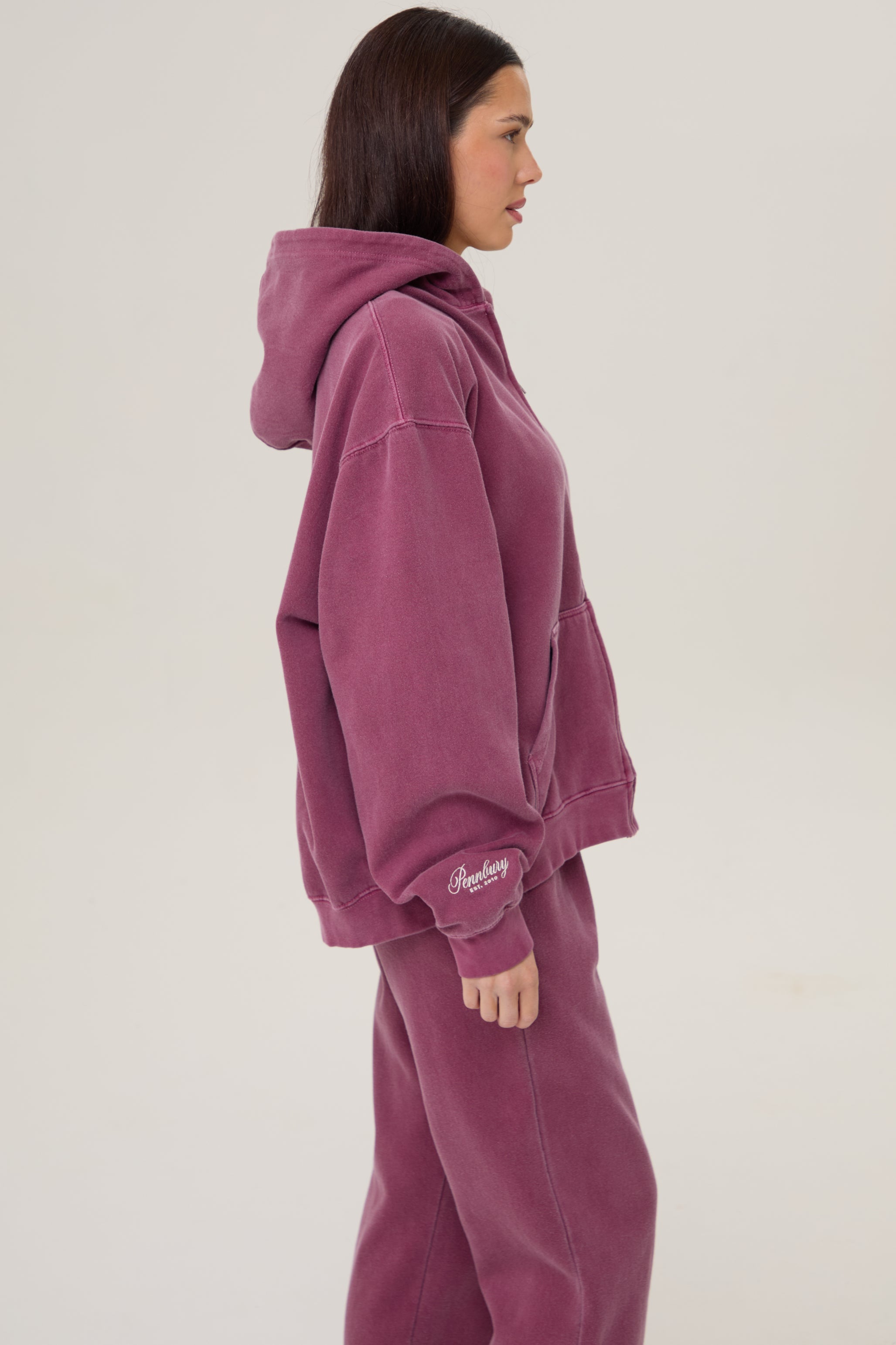 Model wearing Pennbury Regency oversized zip hoodie in vintage wine with joggers