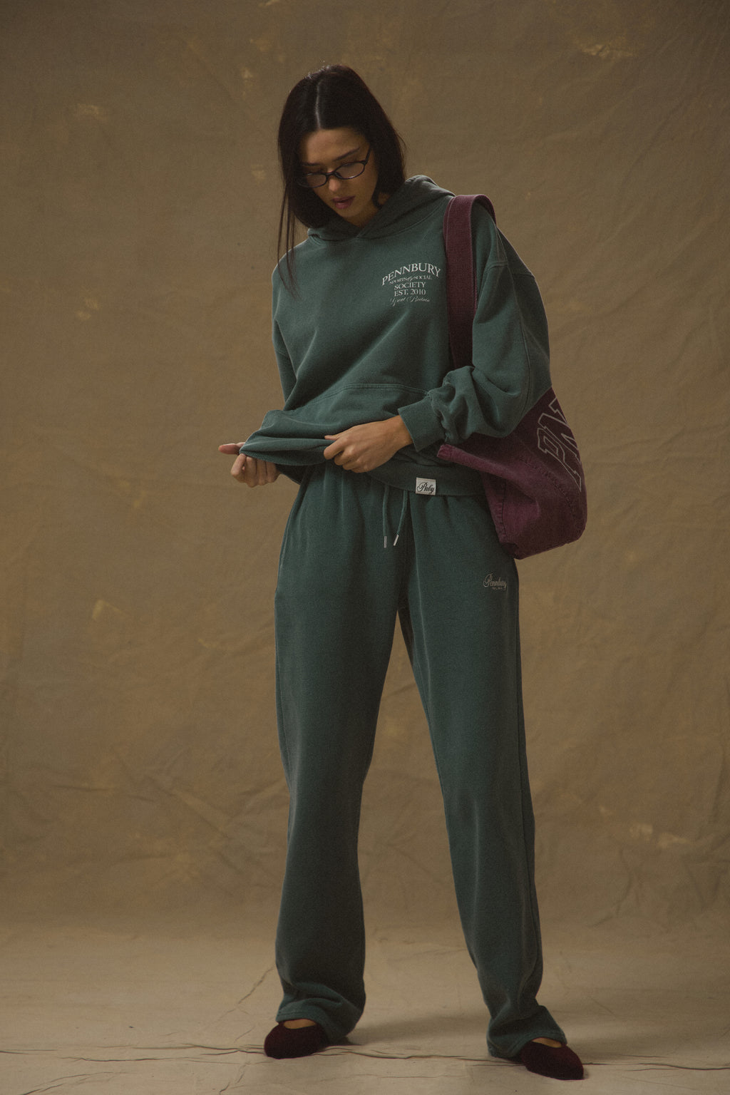 Model wears Pennbury Sports & Social Hoodie in vintage green