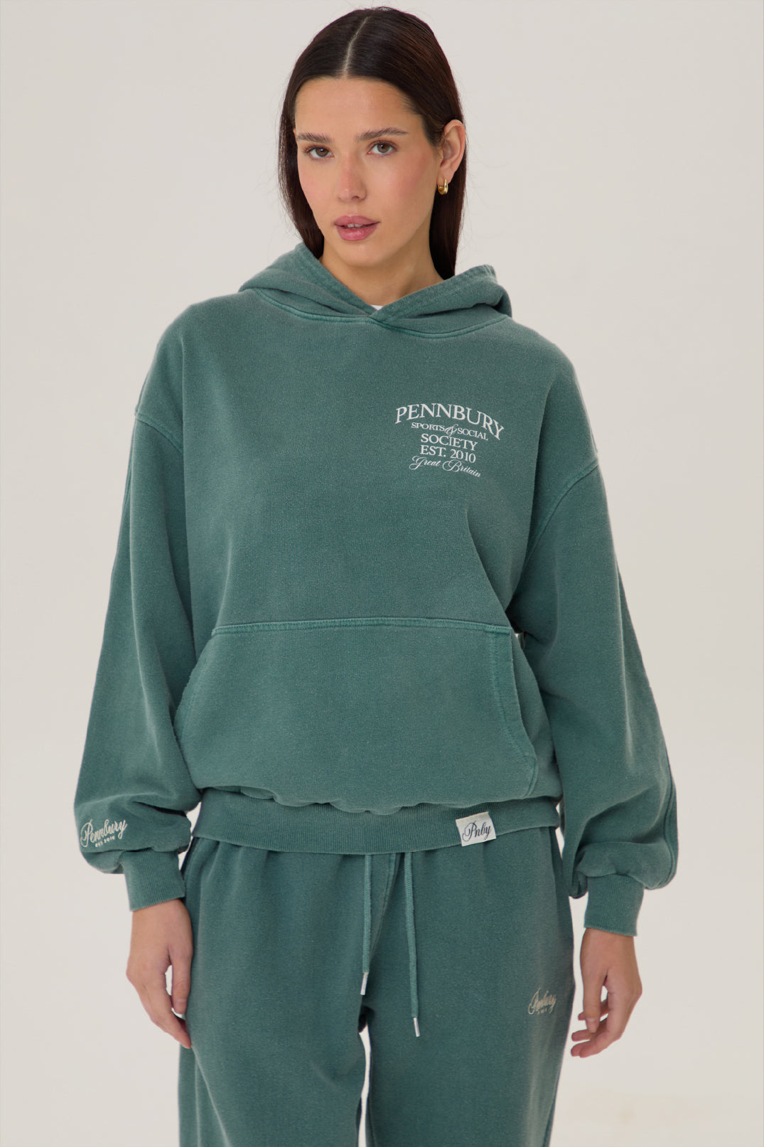 Model wears Pennbury Sports & Social Hoodie in vintage green 