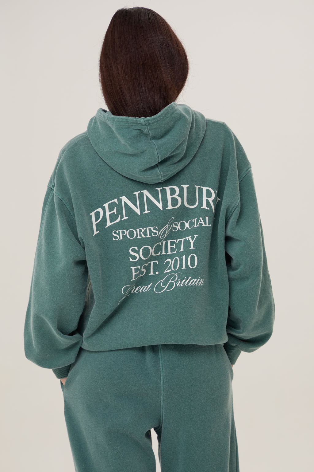 Model wears Pennbury Sports & Social Hoodie in vintage green 