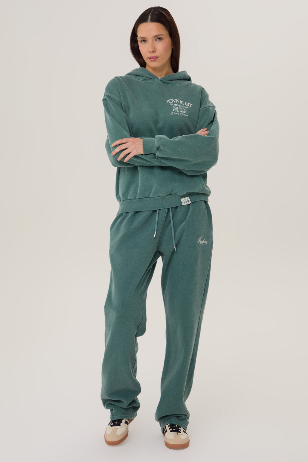 Model wears Pennbury Sports & Social Hoodie in vintage green 