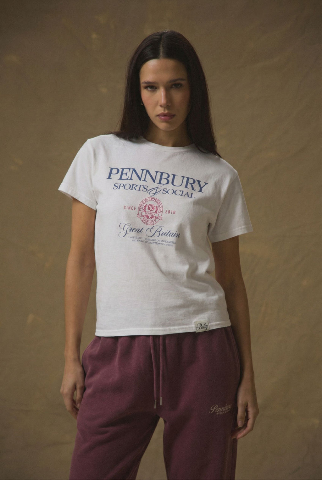 Model wearing Pennbury Sports & Social baby tee styled with joggers