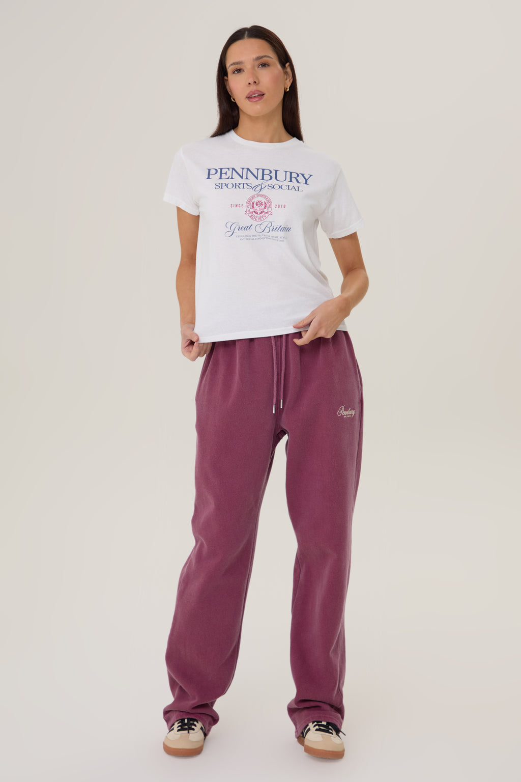 Model wearing Pennbury Sports & Social baby tee styled with joggers