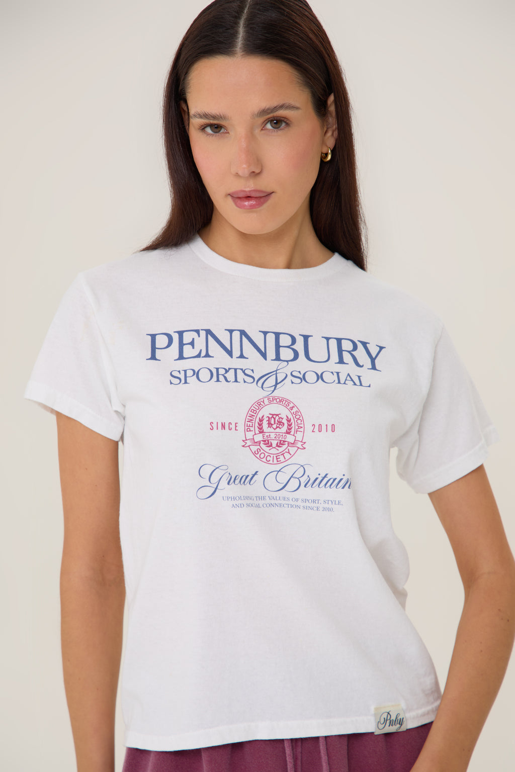 Model wearing Pennbury Sports & Social baby tee styled with joggers