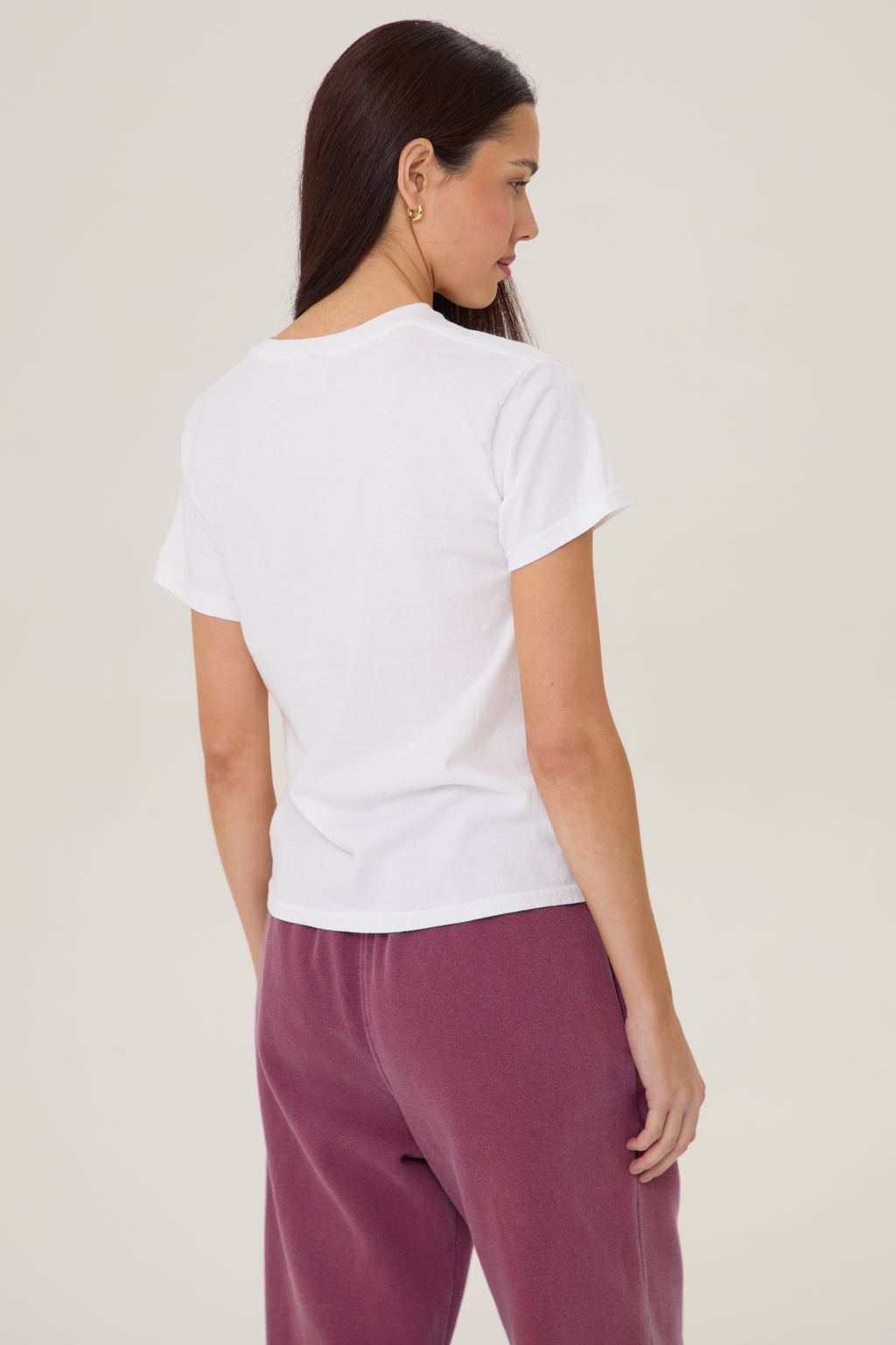Model wearing Pennbury Sports & Social baby tee styled with joggers