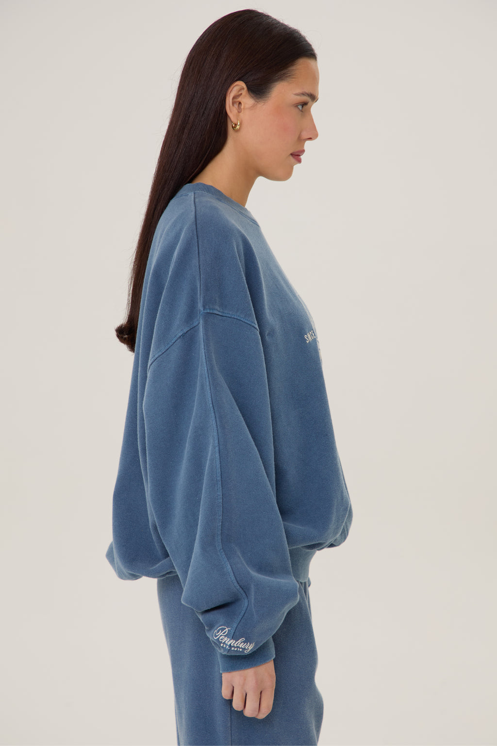 Model wears Pennbury heritage embroidered sweatshirt vintage navy