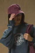 Model wearing Pennbury vintage wine embroidered tennis cap