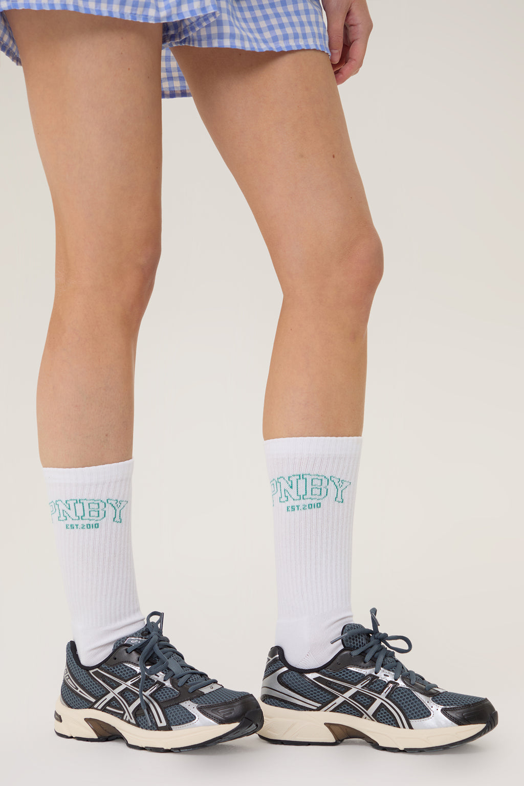Model wearing Pennbury white sports crew socks with shorts