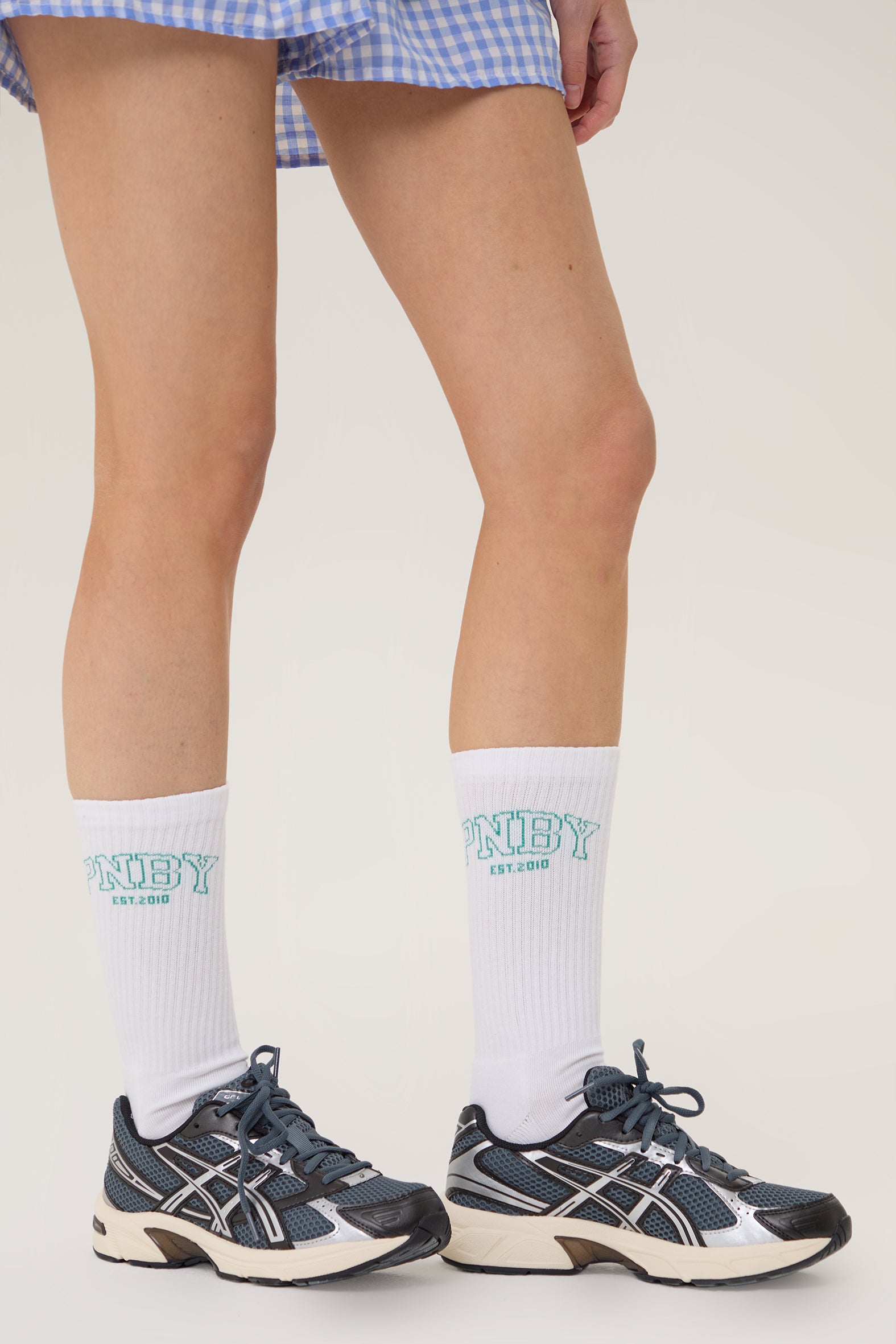 Model wearing Pennbury white sports crew socks with shorts