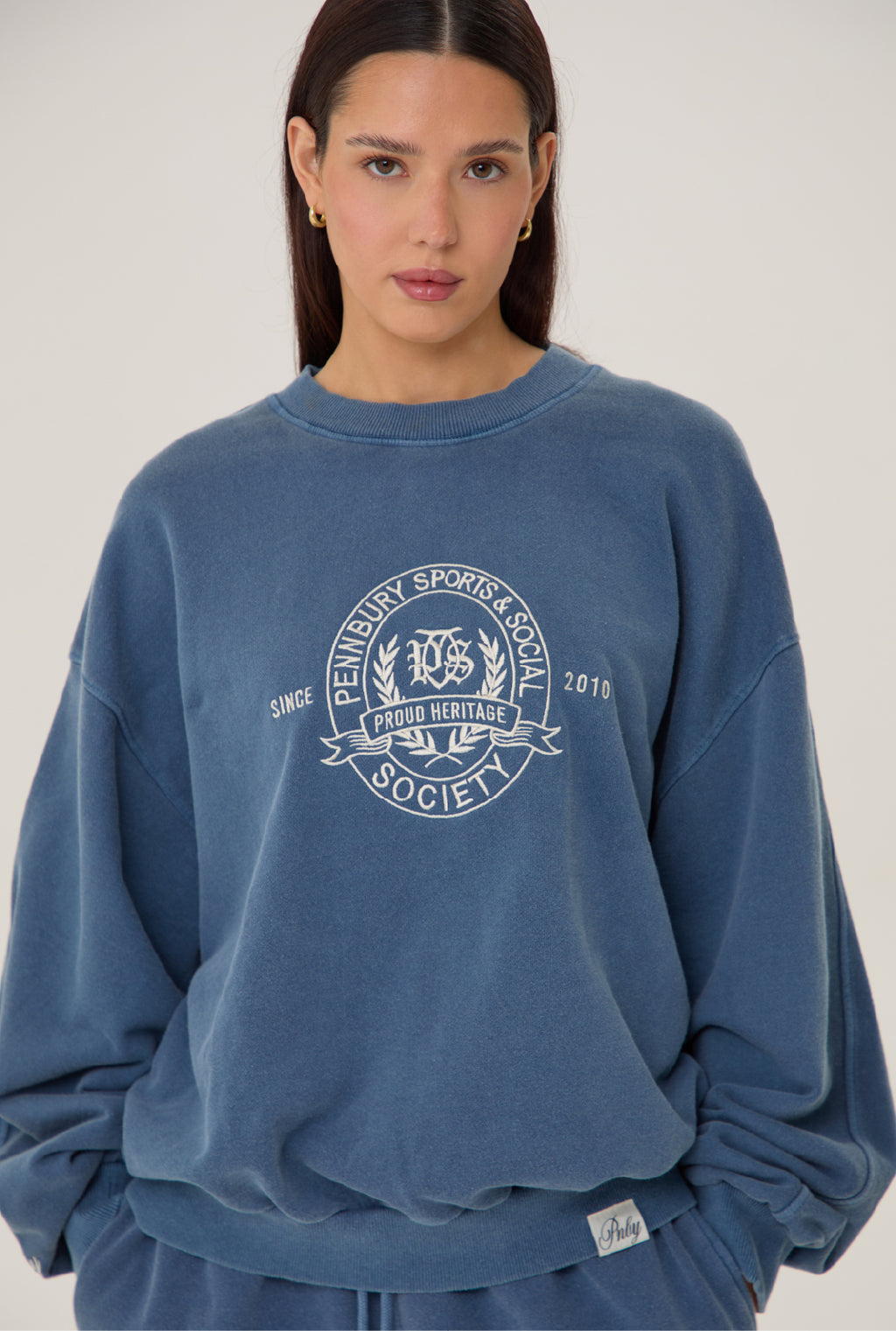 Model wears Pennbury heritage embroidered sweatshirt vintage navy